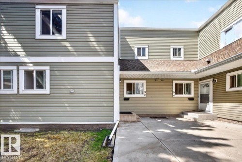 Exterior featuring light green horizontal siding and white trim - 32 1820 56 Street, Edmonton, AB - Outdoor With Exterior