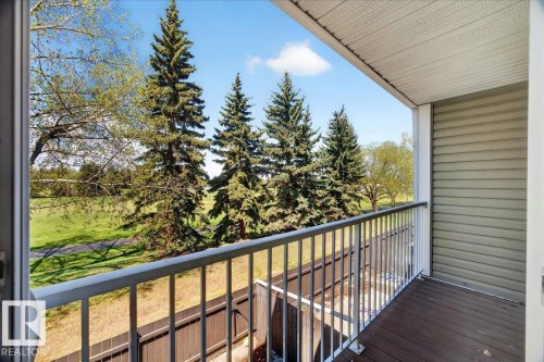 Private balcony with composite decking and a white metal railing, offering expansive green space - 32 1820 56 Street, Edmonton, AB - Outdoor With Balcony With Exterior