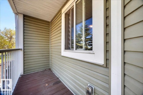 Private balcony featuring wood-finish decking and white railing - 32 1820 56 Street, Edmonton, AB - Outdoor With Exterior