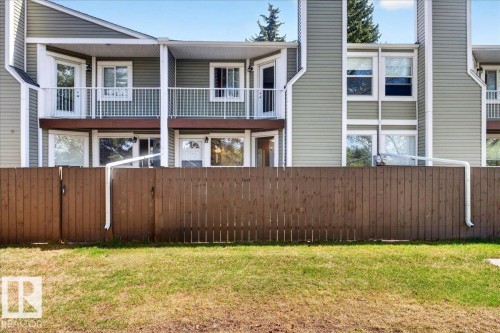 Rear exterior featuring light green horizontal siding and white trim - 32 1820 56 Street, Edmonton, AB - Outdoor With Balcony