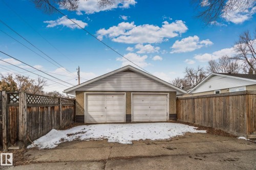 Detached two-car garage featuring a gabled roof and horizontal siding - 12002 37 Street, Edmonton, AB 