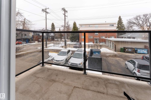 The property features a balcony with a glass railing, providing an outdoor space with an open view - 203 10003 87 Avenue, Edmonton, AB - Outdoor