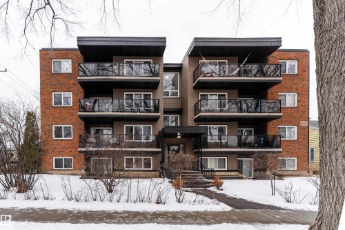 The property features a brick and siding exterior with balconies and multiple windows, providing natural light - 203 10003 87 Avenue, Edmonton, AB - Outdoor With Facade