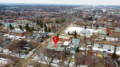 Aerial view showcasing the property's position within a residential area featuring a mix of buildings, bare trees, and snow-covered ground - 203 10003 87 Avenue, Edmonton, AB - Outdoor With View