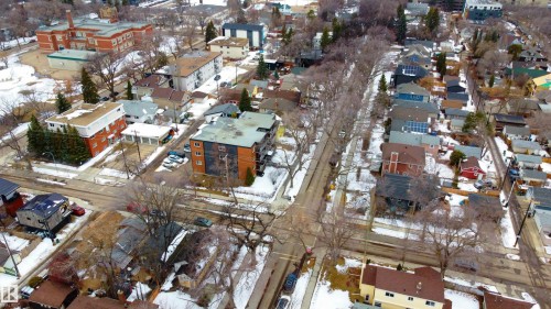 Aerial view showcasing a residential area with varied property types, including multi-story buildings and houses - 203 10003 87 Avenue, Edmonton, AB - Outdoor With View