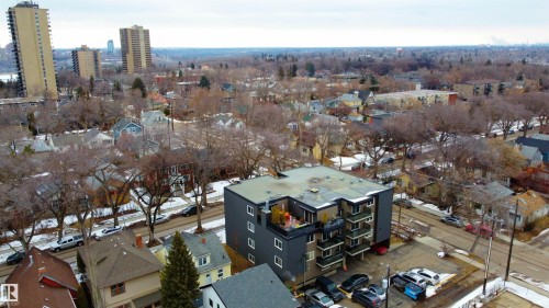 The property features a modern building with several balconies and a rooftop area - 203 10003 87 Avenue, Edmonton, AB - Outdoor With View