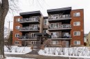 The property features a multi-story exterior with brick and siding, equipped with several private balconies that include glass and metal railings - 203 10003 87 Avenue, Edmonton, AB  - Outdoor With Facade 