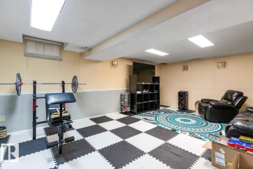 Lower level room featuring checkered floor tiles and light-colored walls with wainscoting - 4340 33 Street, Edmonton, AB - Indoor Photo Showing Basement