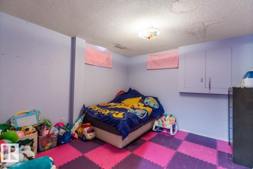 Room featuring checkered floor tiling, built-in wall cabinetry, and recessed wall openings - 4340 33 Street, Edmonton, AB - Indoor Photo Showing Bedroom