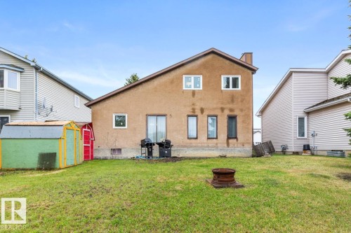Rear exterior with stucco siding and a prominent chimney - 4340 33 Street, Edmonton, AB - Outdoor With Exterior