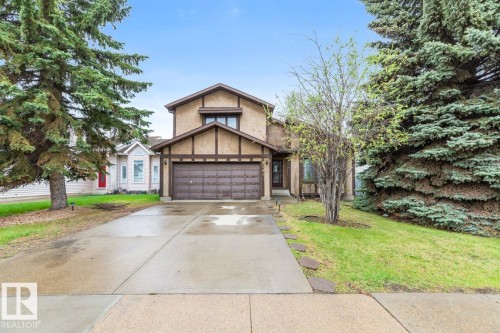 Two-story home featuring stucco siding with dark trim accents, a two-car garage, and a concrete driveway - 4340 33 Street, Edmonton, AB - Outdoor With Facade
