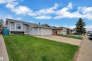 Light blue siding exterior featuring a prominent bay window and an attached garage with a white door - 3227 145 Avenue, Edmonton, AB  - Outdoor 