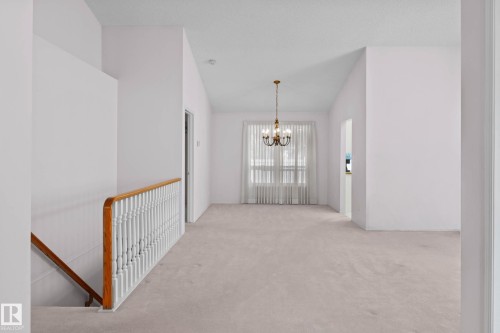 Spacious room with vaulted ceilings and neutral carpeting - 12 9718 176 Street, Edmonton, AB - Indoor Photo Showing Other Room