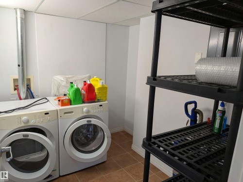 Dedicated laundry area featuring tile flooring and ample storage space. - 419 4304 139 Avenue, Edmonton, AB - Indoor Photo Showing Laundry Room