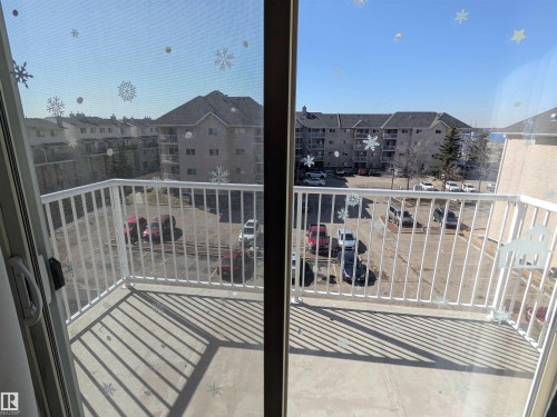 Outdoor south facing balcony featuring a white metal railing and a concrete floor - 419 4304 139 Avenue, Edmonton, AB - Outdoor With Balcony