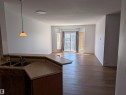 Bright South Facing Living room provides lots of sunlight with sliding glass doors to a private balcony. - 419 4304 139 Avenue, Edmonton, AB  - Indoor Photo Showing Kitchen With Double Sink 