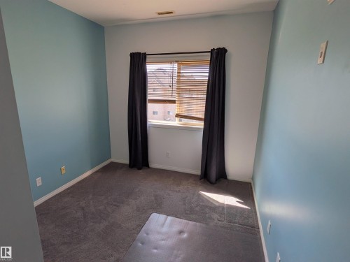 Well-sized bedroom offering versatile space for family, guests, or a home office setup. - 419 4304 139 Avenue, Edmonton, AB - Indoor