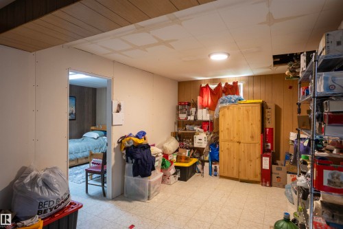 Room featuring vinyl tile flooring and a partial suspended ceiling - 10428 68 Avenue, Edmonton, AB - Indoor