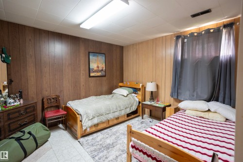 Room featuring two distinct wood paneling styles - 10428 68 Avenue, Edmonton, AB - Indoor Photo Showing Bedroom
