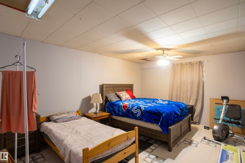 Recessed ceiling panels and a ceiling fan with integrated lighting - 10428 68 Avenue, Edmonton, AB - Indoor Photo Showing Bedroom