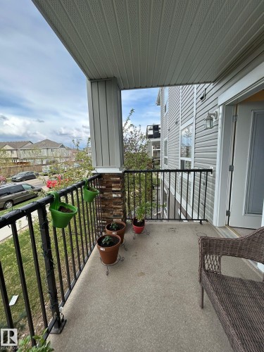 Private balcony featuring a concrete floor, black metal railings, and an exterior light fixture - 1228 9363 Simpson Drive, Edmonton, AB - Outdoor With Exterior