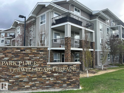 Multi-story residential building featuring balconies with black metal railings - 1228 9363 Simpson Drive, Edmonton, AB - Outdoor