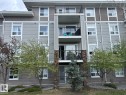 Multi-level residential building featuring balconies with black metal railings, light grey horizontal siding, and brown shake siding accents - 1228 9363 Simpson Drive, Edmonton, AB  - Outdoor With Facade 
