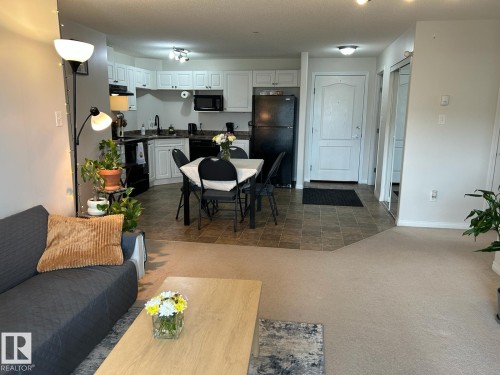 Open-concept living area featuring a kitchen, dining space, and entryway - 1228 9363 Simpson Drive, Edmonton, AB - Indoor