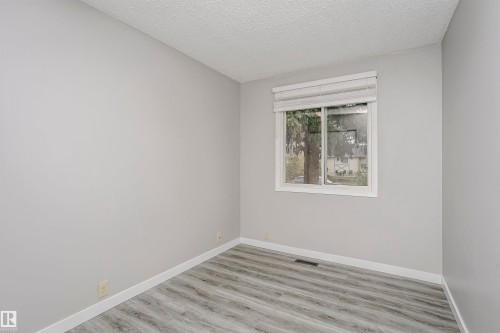 Bedroom 3 on main floor with vinly plank flooring. - 11436 161 Avenue, Edmonton, AB - Indoor Photo Showing Other Room