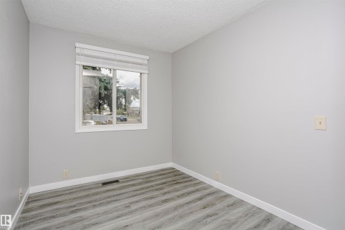 Bedroom 3 on main floor with vinly plank flooring. - 11436 161 Avenue, Edmonton, AB - Indoor Photo Showing Other Room