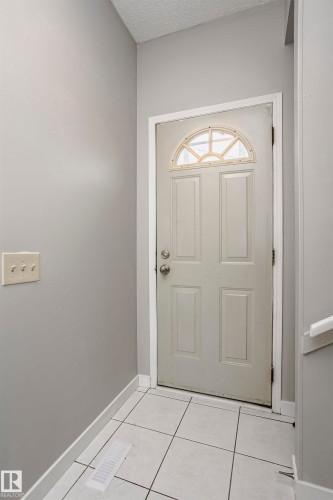 Back entry foyer with tile flooring leading to basement, as well as main floor and back yard. Could be a potential basement suite entrance. - 11436 161 Avenue, Edmonton, AB - Indoor Photo Showing Other Room