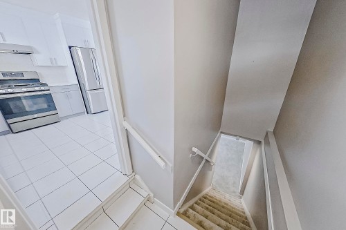 Staircase to basement with new plush carpet. This rear entry would be ideal for a future suite. - 11436 161 Avenue, Edmonton, AB - Indoor Photo Showing Other Room