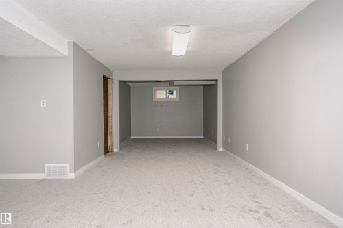 Huge family room with new plush carpet.  Lots of room to add bedroom 5 at the end with a window if desired. - 11436 161 Avenue, Edmonton, AB - Indoor Photo Showing Other Room