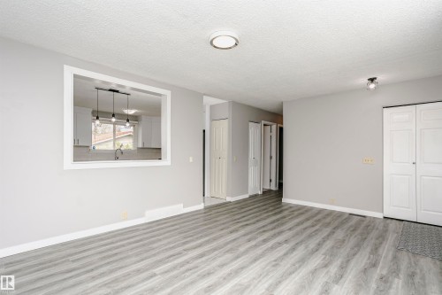 Convenient cut through window from living room into kitchen and dinette area adds natural light. - 11436 161 Avenue, Edmonton, AB - Indoor Photo Showing Other Room