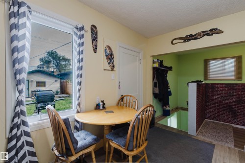 Bright dining area featuring a window overlooking the backyard - 10834 75 Avenue, Edmonton, AB - Indoor Photo Showing Dining Room