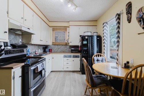 Kitchen featuring light-toned wood-finish flooring - 10834 75 Avenue, Edmonton, AB - Indoor