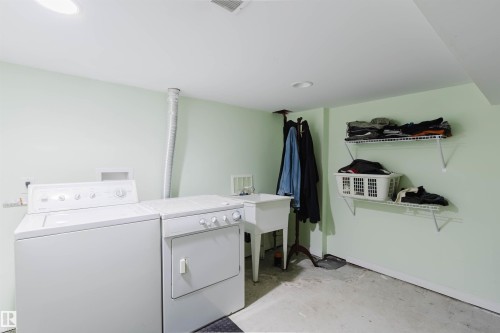Dedicated utility area featuring a wall-mounted sink, built-in recessed lighting, and durable concrete flooring - 10834 75 Avenue, Edmonton, AB - Indoor Photo Showing Laundry Room