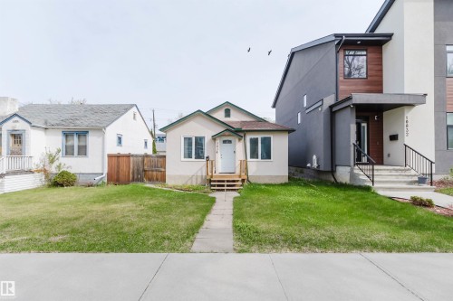 Single-story residence featuring a neutral-toned exterior, white trim, and a gabled roof - 10834 75 Avenue, Edmonton, AB - Outdoor With Facade