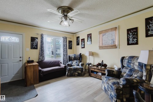 Bright living area with light-toned wood-finish flooring - 10834 75 Avenue, Edmonton, AB - Indoor