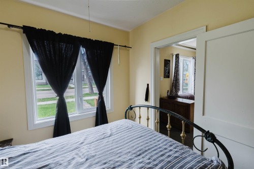 Room featuring light yellow walls and white trim - 10834 75 Avenue, Edmonton, AB - Indoor Photo Showing Bedroom