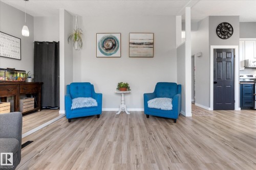 Spacious room featuring light wood-finish flooring, light gray walls, and white baseboards - 4759 48 Street, Onoway, AB - Indoor