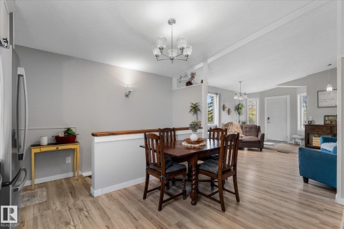 Dining area featuring a contemporary chandelier and wood-finish flooring - 4759 48 Street, Onoway, AB - Indoor Photo Showing Dining Room