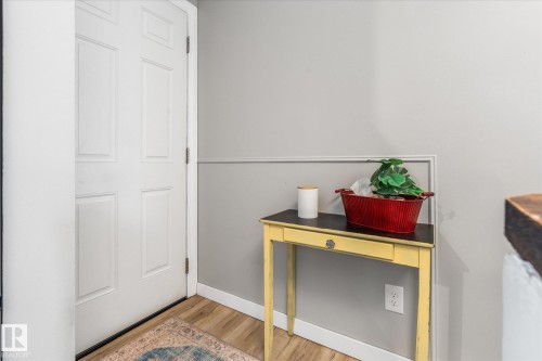 White paneled door with wood-finish flooring - 4759 48 Street, Onoway, AB - Indoor Photo Showing Other Room