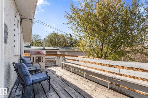 Spacious outdoor deck featuring natural wood flooring and a built-in wooden bench - 4759 48 Street, Onoway, AB - Outdoor With Deck Patio Veranda