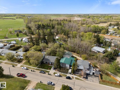 Aerial view showcasing a residential street with single-story homes and mature trees - 4759 48 Street, Onoway, AB - Outdoor With View