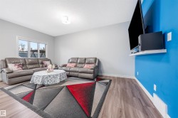 Bright living area featuring wood-finish flooring and a large window - 