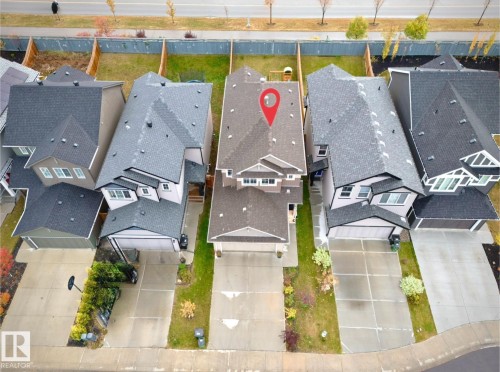 Contemporary two-story home featuring a dark shingle roof and light-toned siding - 1024 Daniels Loop, Edmonton, AB 
