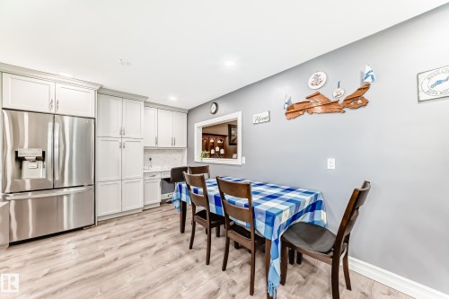 Kitchen and dining area featuring light wood-finish flooring - 4006 115 Avenue, Edmonton, AB 