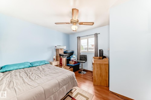 Light blue interior walls with wood-finish flooring - 4006 115 Avenue, Edmonton, AB 