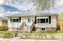 White siding exterior with a shingled roof, featuring a front porch with wooden steps and railing - 4006 115 Avenue, Edmonton, AB 